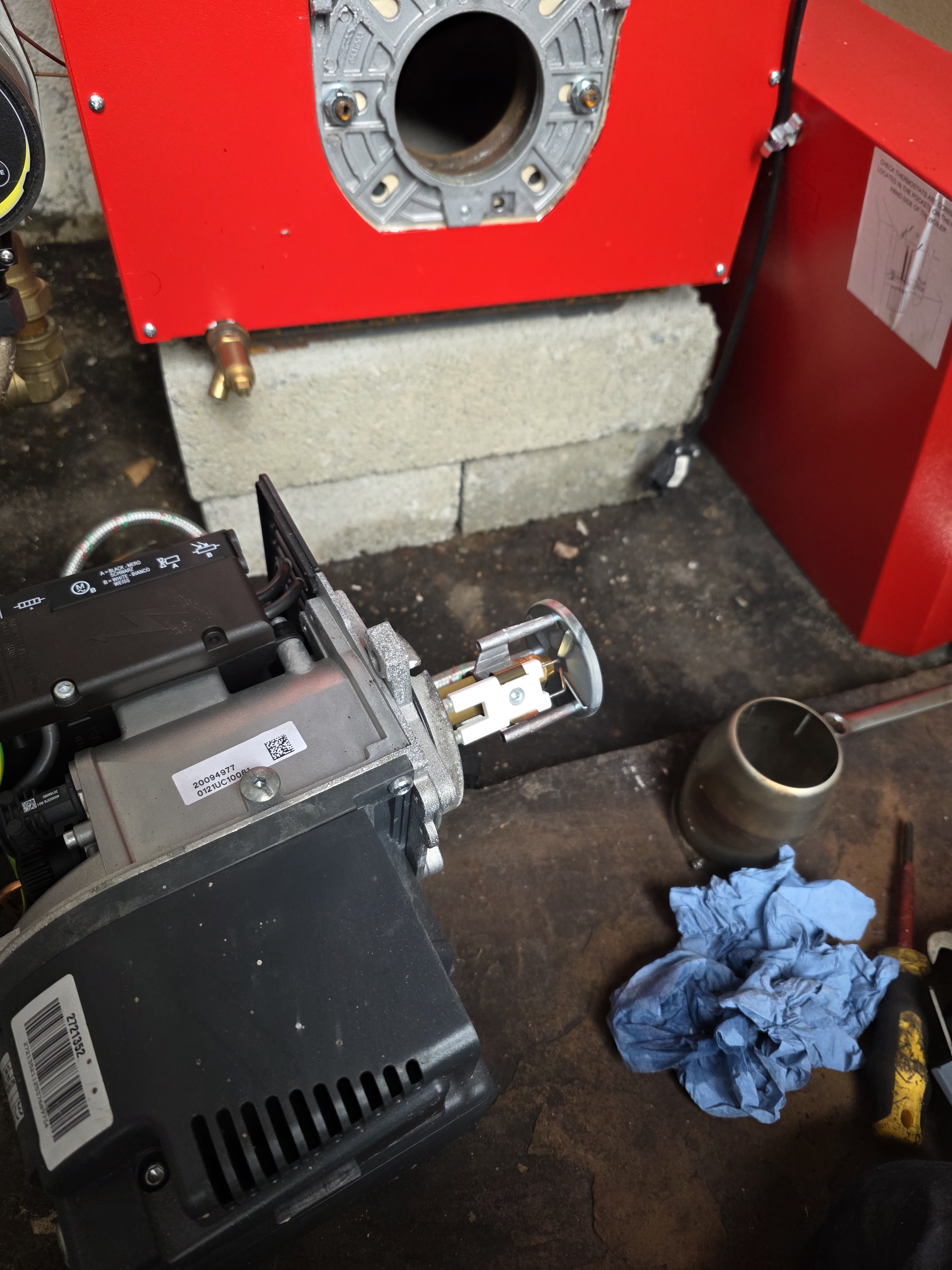 Oil boiler burner removed for cleaning and service during an annual boiler check